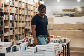 Customer browsing published titles in a bookstore