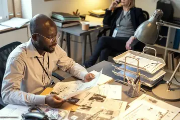 Editorial team reviewing a manuscript in the office